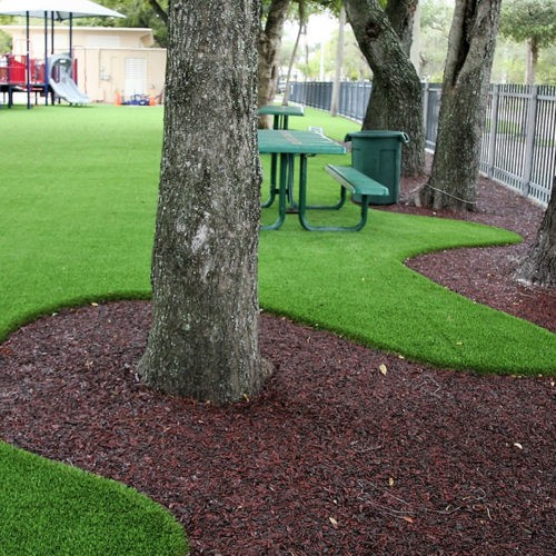 artificial grass and rubber mulch on public park and playground